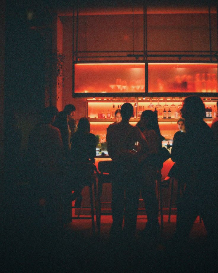 A lively bar glowing red late at night