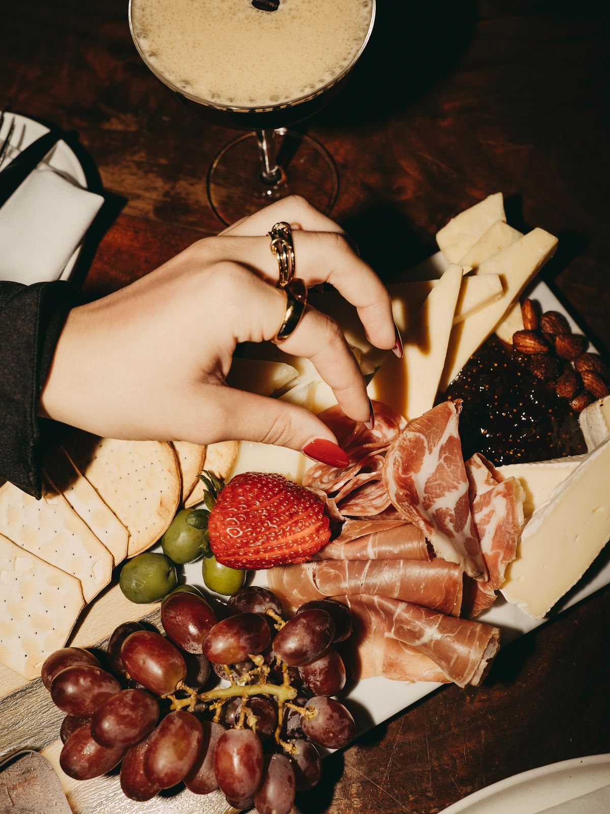 Charcuterie board with cheese, fruit, and cured meats