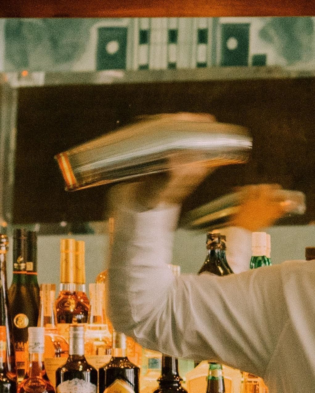 Bartender shaking a cocktail behind the bar